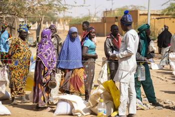 Displaced people wait in line for food distribution in Gorom-Gorom, Burkina Faso.