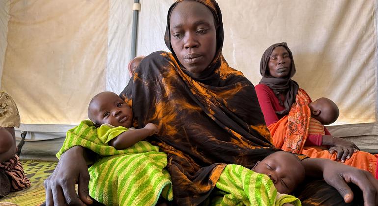 A Sudanese refugee sits with her three-month-old twins at a UNICEF-supported breastfeeding and nutrition awareness centre in Eastern Chad.