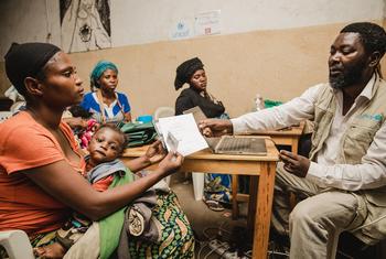 A woman in South Kivu province, DR Congo, is given a mobile phone by UNICEF so she can receive cash transfers to support her family.