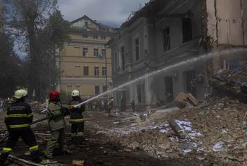 Firefighters extinguish a fire in a building struck by a missile in Kyiv, Ukraine.