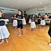 Michael Pili Pang (right) runs a hula dance school in Honolulu, Hawaii