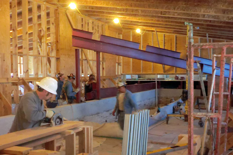 Workers Construct New Permanent Roof under Temporary Roof Structure