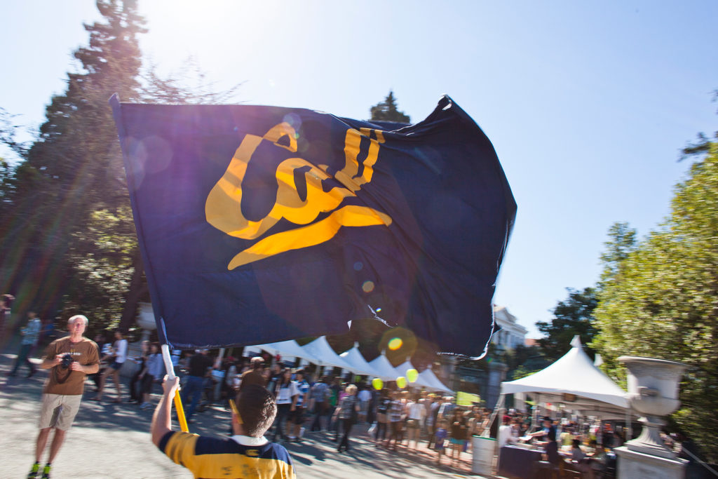 student waving Cal flag