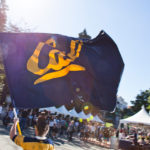 student waving Cal flag