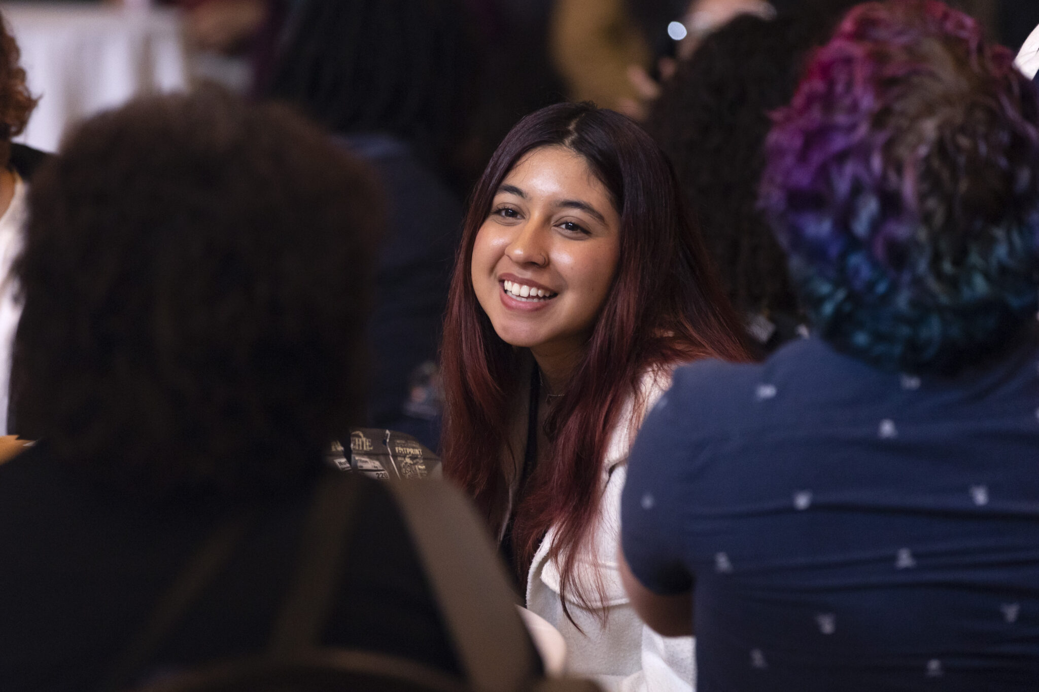 female student pictured smiling in the crowd