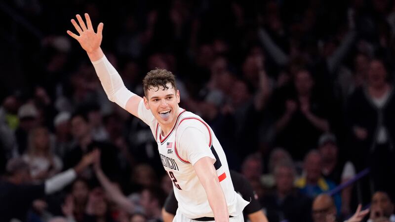 UConn center Donovan Clingan reacts after dunking during the second half of an NCAA college...