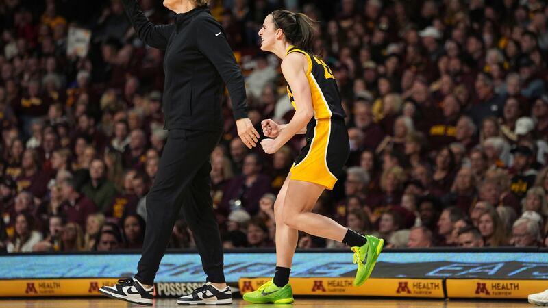 Iowa guard Caitlin Clark, right, celebrates next to coach Lisa Bluder after an Iowa basket...