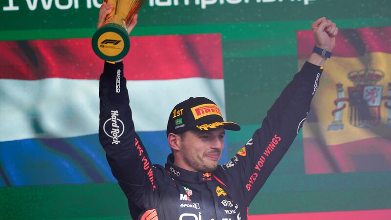 Red Bull driver Max Verstappen of the Netherlands celebrates at the podium after winning the...