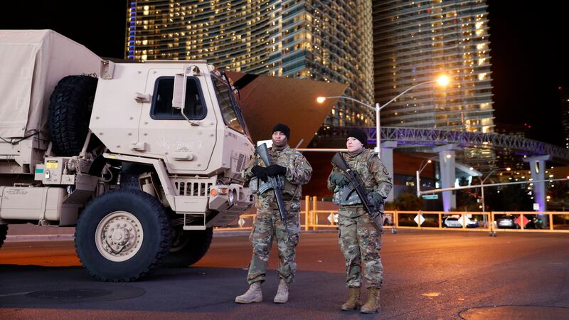 Members of the Nevada National Guard stand at a roadblock on a road leading to the Las Vegas...