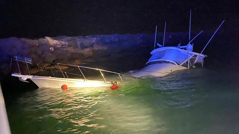 This photo provided by the Long Beach, Calif., Fire Department shows a power boat that crashed...