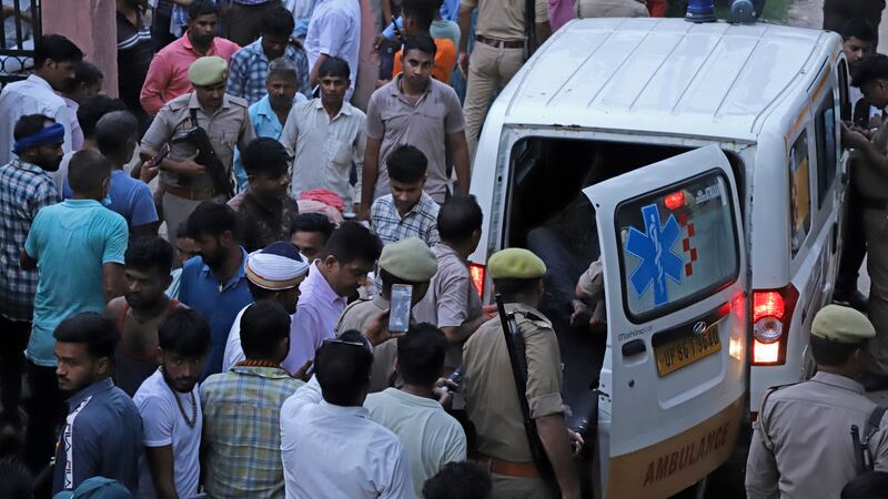 An injured arrives in an ambulance at the Sikandrarao hospital in Hathras district about 350...