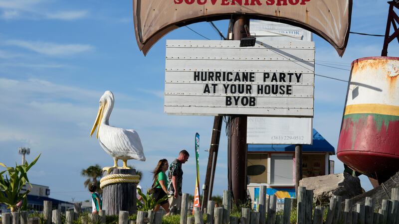 Visitors pass a restaurant closed in advance of Beryl, Saturday, July 6, 2024, in Port...