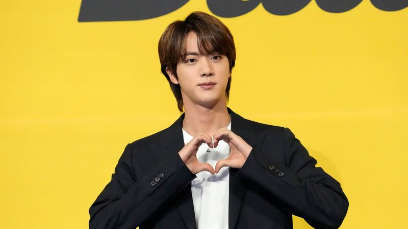 Jin, a member of South Korean K-pop band BTS poses for photographers ahead of a press...