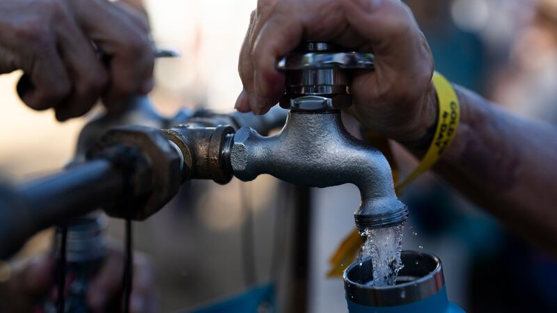 People fill up their water bottles while attending the Waterfront Blues Festival on Friday,...