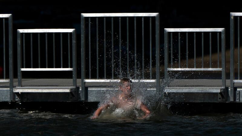 A child jumps off the dock at Cathedral City Park into the Willamette River on Friday, July 5,...