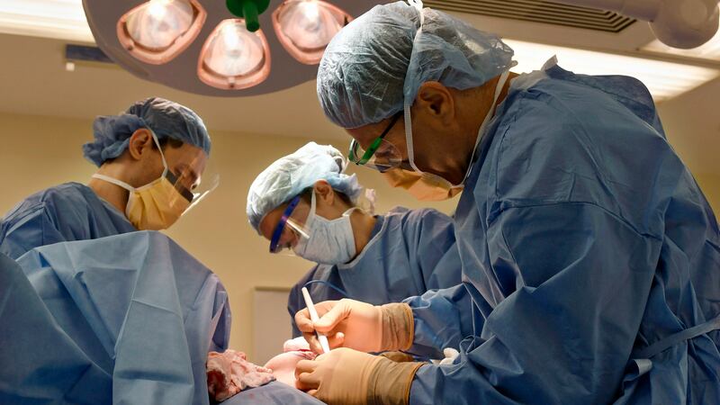 FILE - Surgeons perform a bilateral mastectomy on a transgender patient at a hospital in...