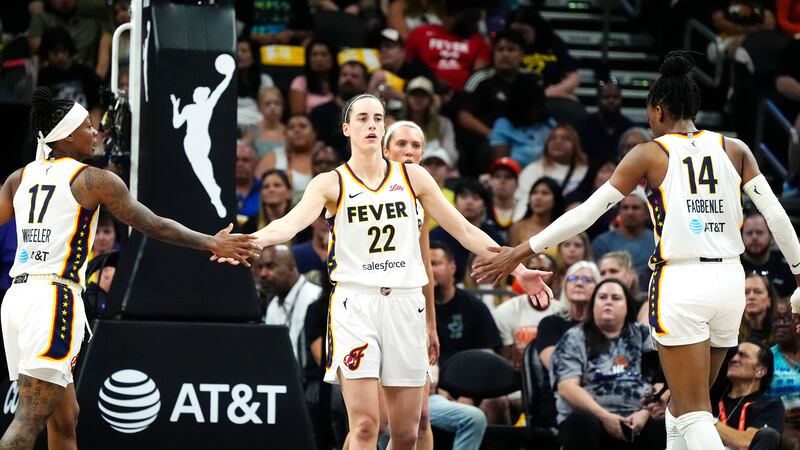 Indiana Fever guard Caitlin Clark (22) is congratulated by Fever guard Erica Wheeler (17) and...