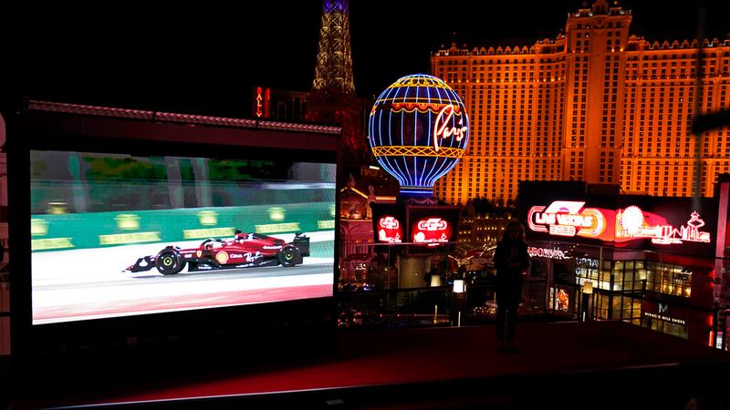 A screen show Charles Leclerc driving a Ferrari, during a news conference announcing a 2023...