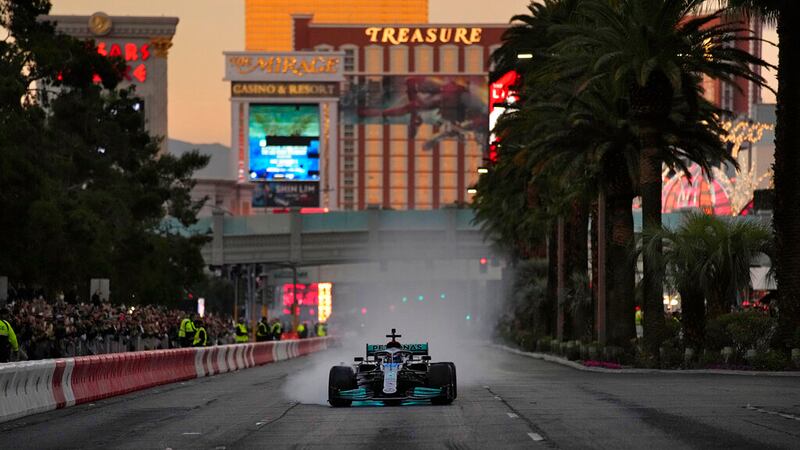 Mercedes' George Russell drives during a demonstration along the Las Vegas Strip at a launch...