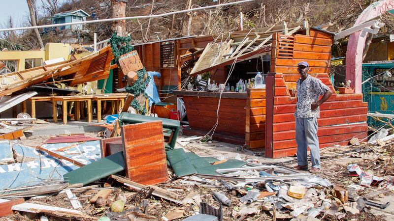 A man stands next to a business destroyed by Hurricane Beryl in Clifton, Union Island, St....