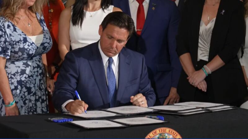 DeSantis sings bills protecting children during a news conference on April 10, 2024.