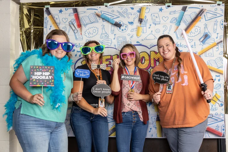 teachers posing in photo booth