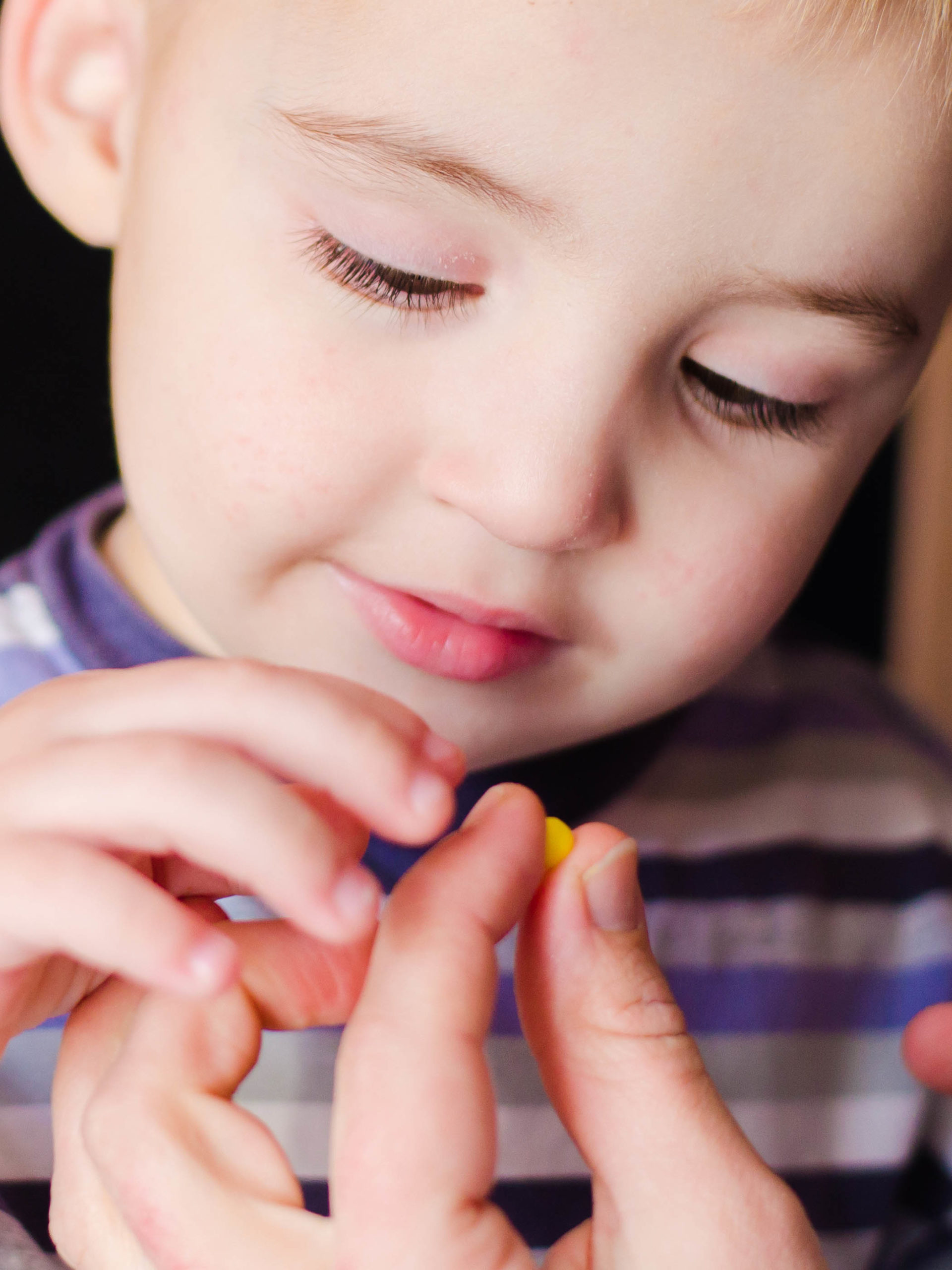 Mom giving little boy pill medication to take