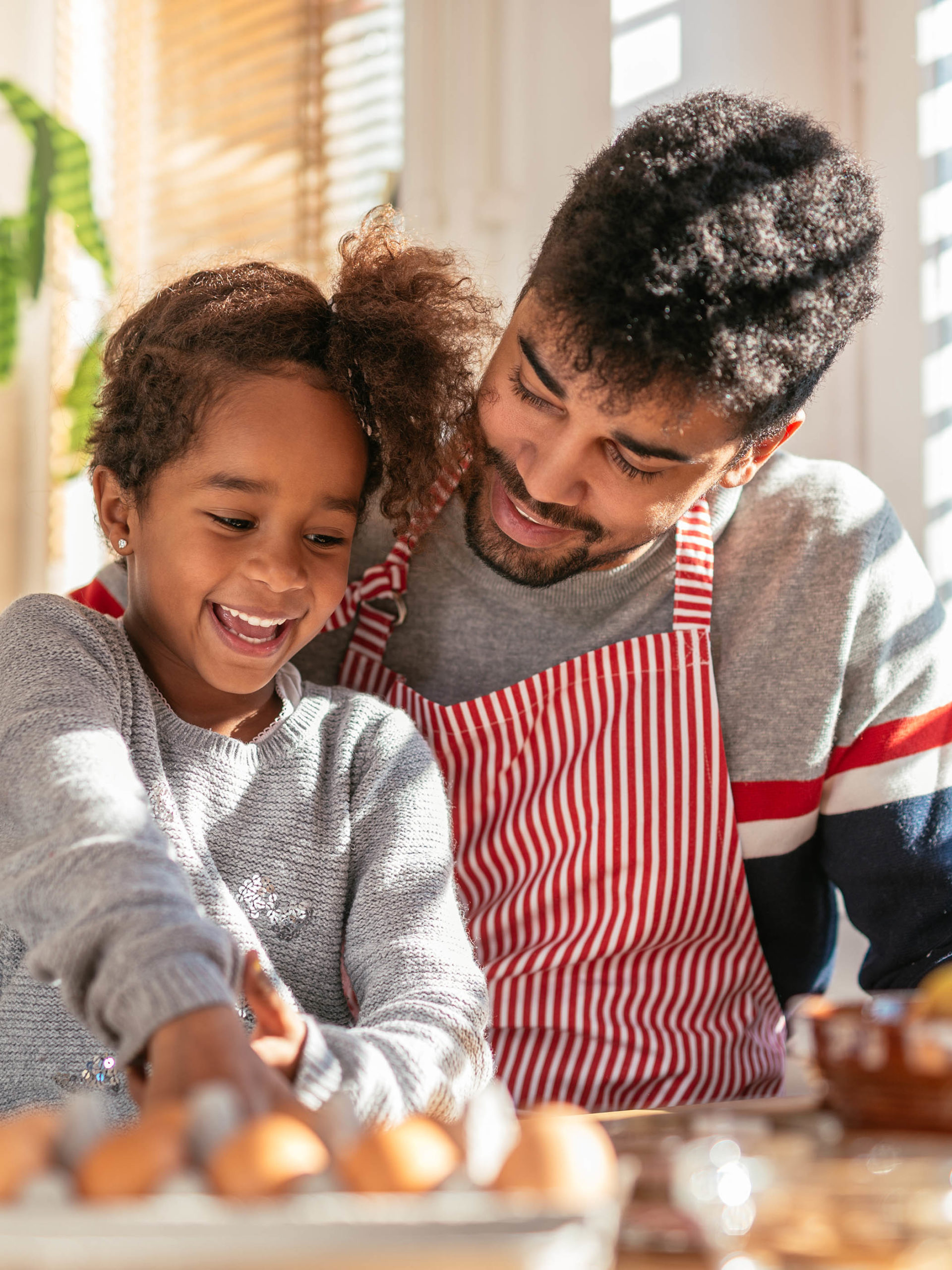 father and daughter baking in the kitchen and having fun