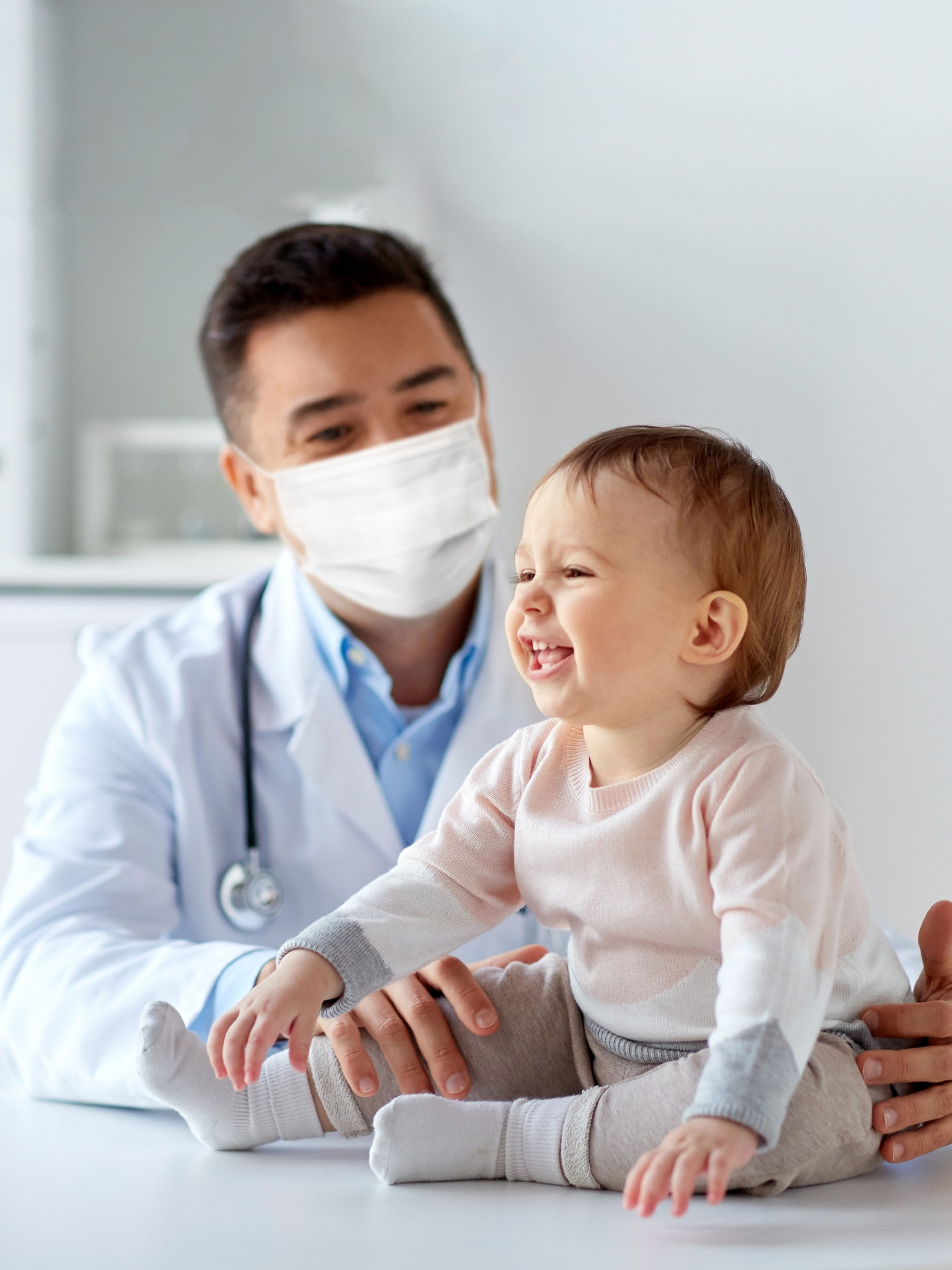 baby gets checked out by doctor at development screening