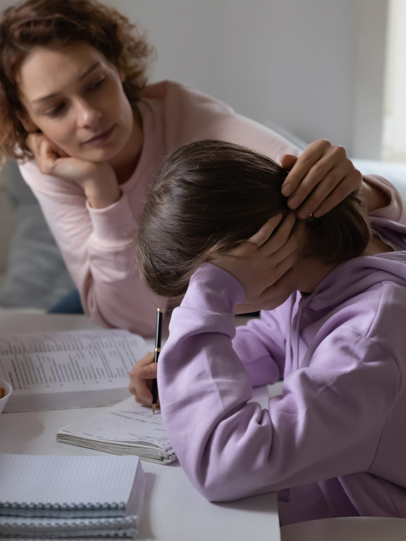 mother supporting sad daughter while she tries to get through the day