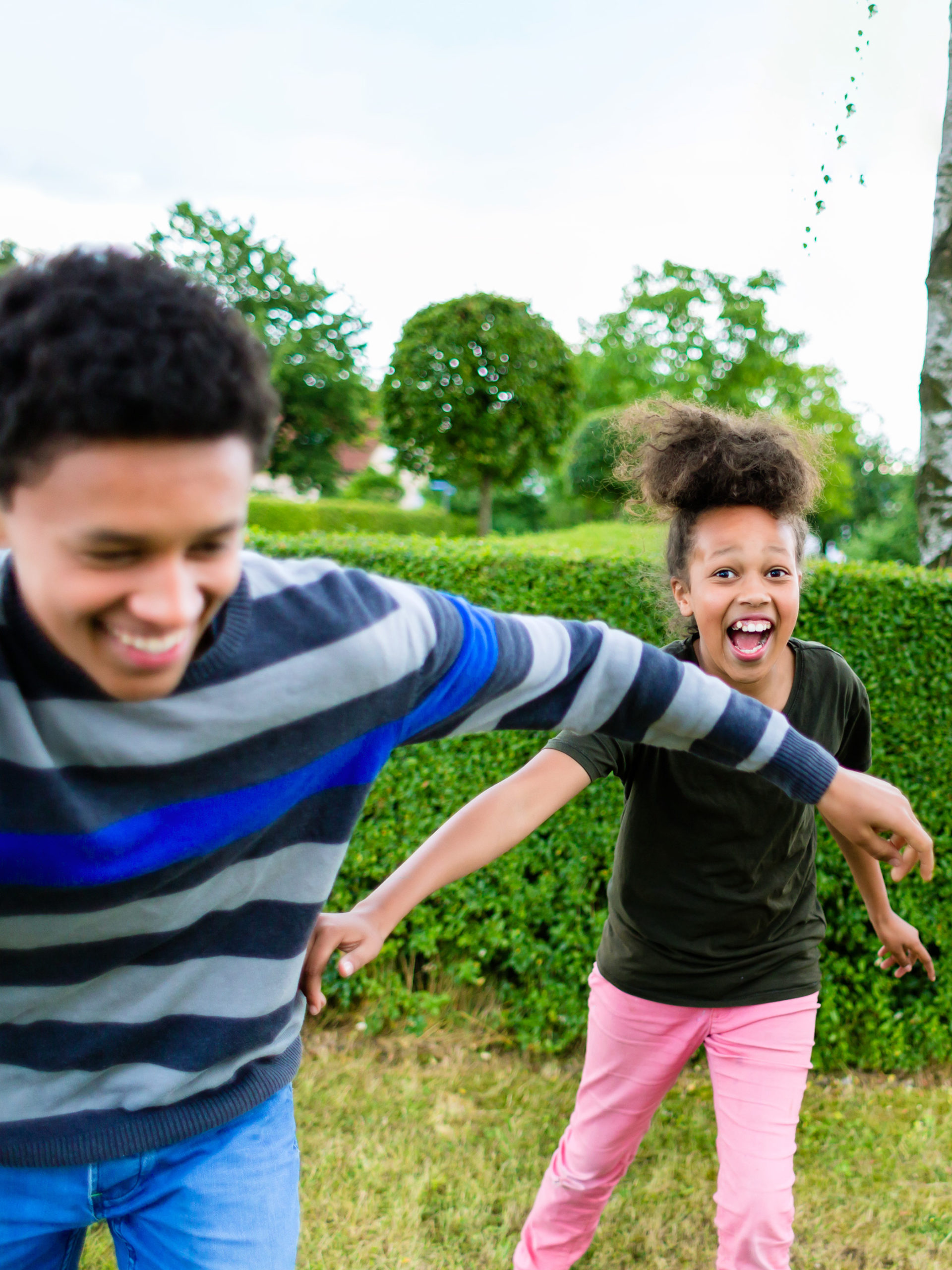 two kids playing tag and laughing