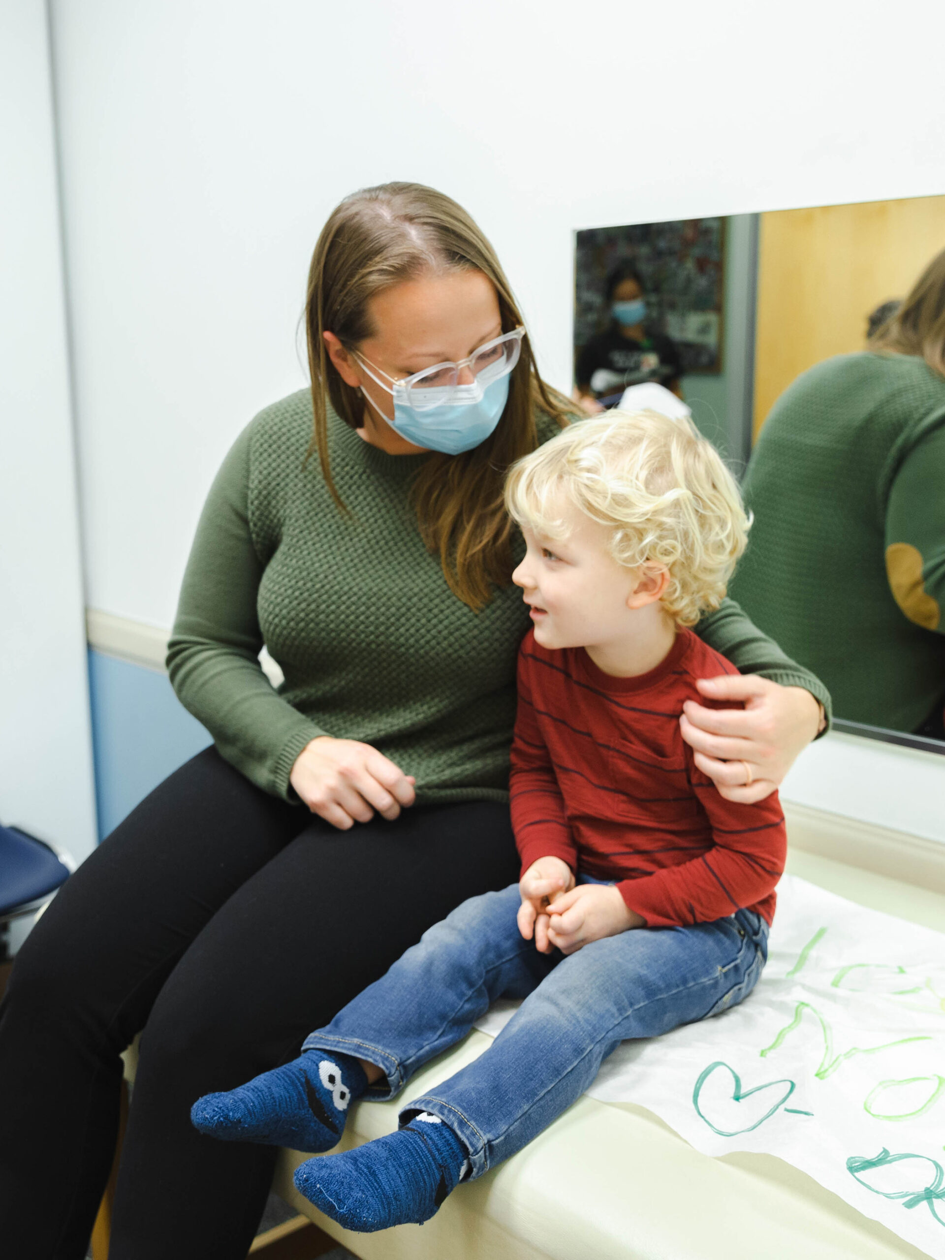 Child in parent talk while waiting for the doctor