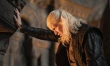 Daemon Targaryen braces himself against a wall with one hand, staring deep into a fireplace.