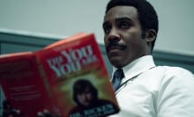 A man in a white button-up and dark tie reads a book titled "The You You Are"