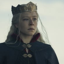 Rhaenyra Targaryen in a black gown with a crown on her head.