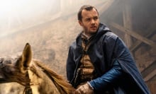 Matthew Shardlake from "Shardlake" rides a horse while wearing a blue cloak.