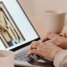 Hands on laptop showing image of clothing