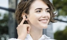 woman smiling wearing baseus earbuds