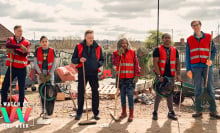 Six people (the cast of "The Outlaws) wearing red community service vests and standing in a line while holding tools. 