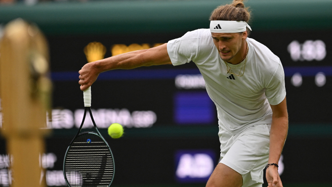 Alexander Zverev returns the ball at Wimbledon