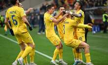 The Romania team celebrate a goal