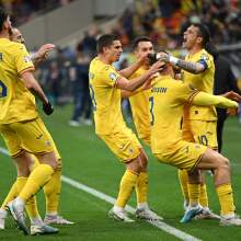 The Romania team celebrate a goal