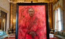 A portrait of King Charles in a black frame. The portrait is mostly red, and a butterfly is about to rest on the King's shoulder.