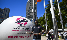 USA Cricket Vice-Captain Aaron Jones taps a ball with a bat next to a giant T20 marketing cricket ball