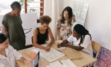 Group of people working together at a table.