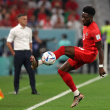 Alphonso Davies controls the ball 