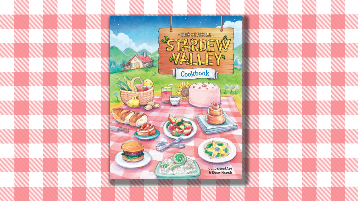 A picnic blanket pattern beneath the cover of the Stardew Valley Cookbook.