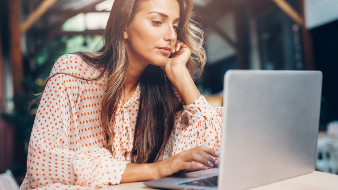 woman browsing the web on laptop in public