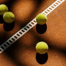 Tennis balls on a clay court