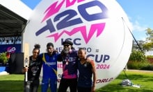 Chris Gayle of the West Indies poses with young Barbados cricketers